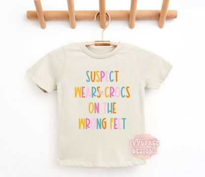 Suspect wears crocs on the wrong feet- toddler tee
